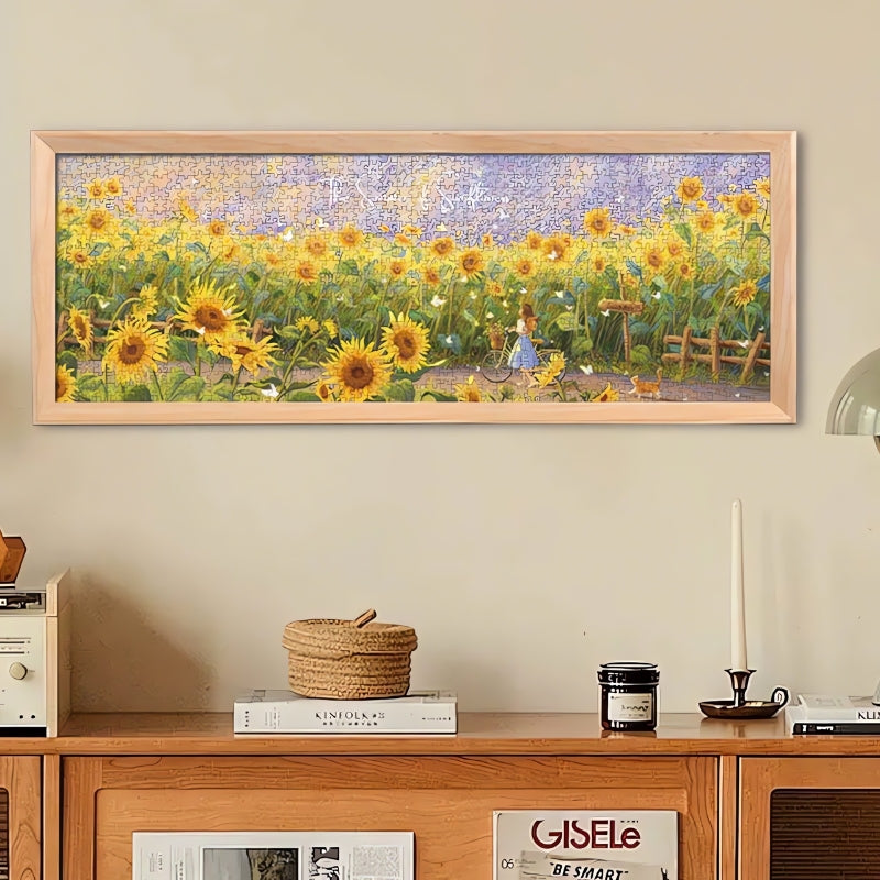 Completed Summer of Sunflowers puzzle in frame on a wooden cabinet.