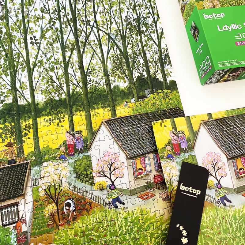 Partially assembled Idyllic Spring puzzle on table with vibrant trees and houses, puzzle box nearby.