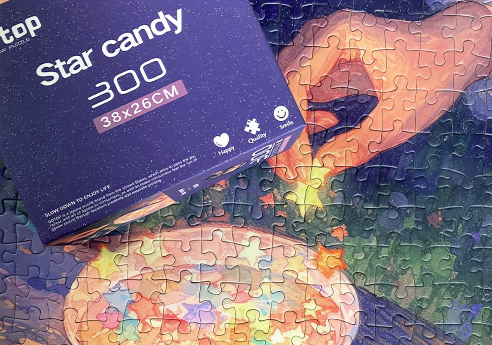 Puzzle close-up showing hand placing star-shaped candy into a teacup with the box partially visible.