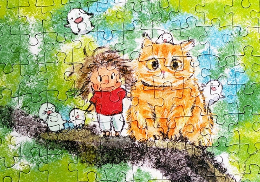 Close-up of assembled puzzle showing a smiling girl and cat on a tree branch.