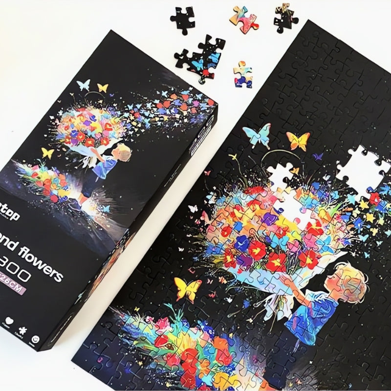 Partially completed Botop Send Flowers puzzle with loose pieces and box showing colourful artwork of boy and bouquet