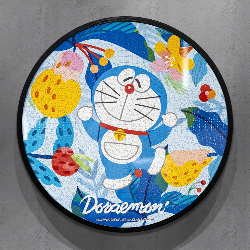 Round puzzle of Doraemon smiling with arms raised, surrounded by vibrant tropical leaves and fruit.