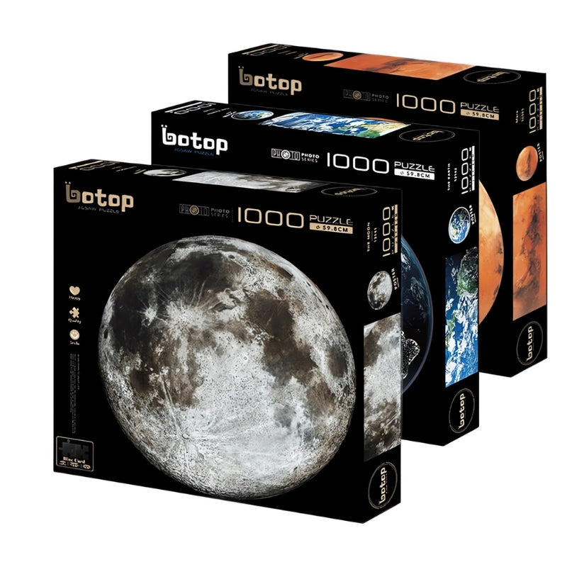 Moon, Earth, and Mars Botop puzzles displayed in sleek black 1000-piece boxes.