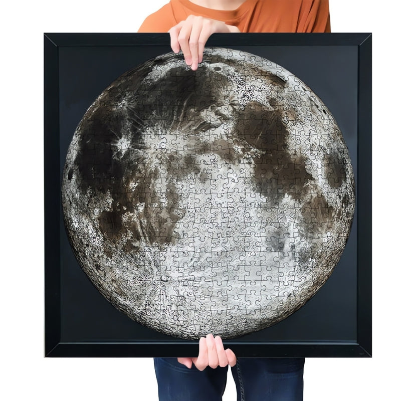 Framed moon puzzle held up, showing realistic lunar surface in high detail.