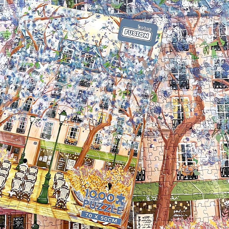 Jacaranda puzzle box resting over finished artwork of tree-lined café street