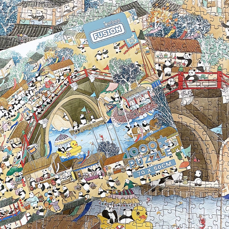 Panda Picture puzzle box resting on finished scene of pandas in village and water parade