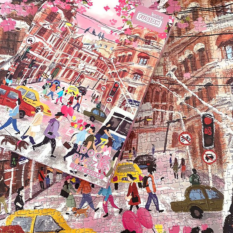 Completed Romantic Corner puzzle with box on top, showing city traffic and cherry blossoms.