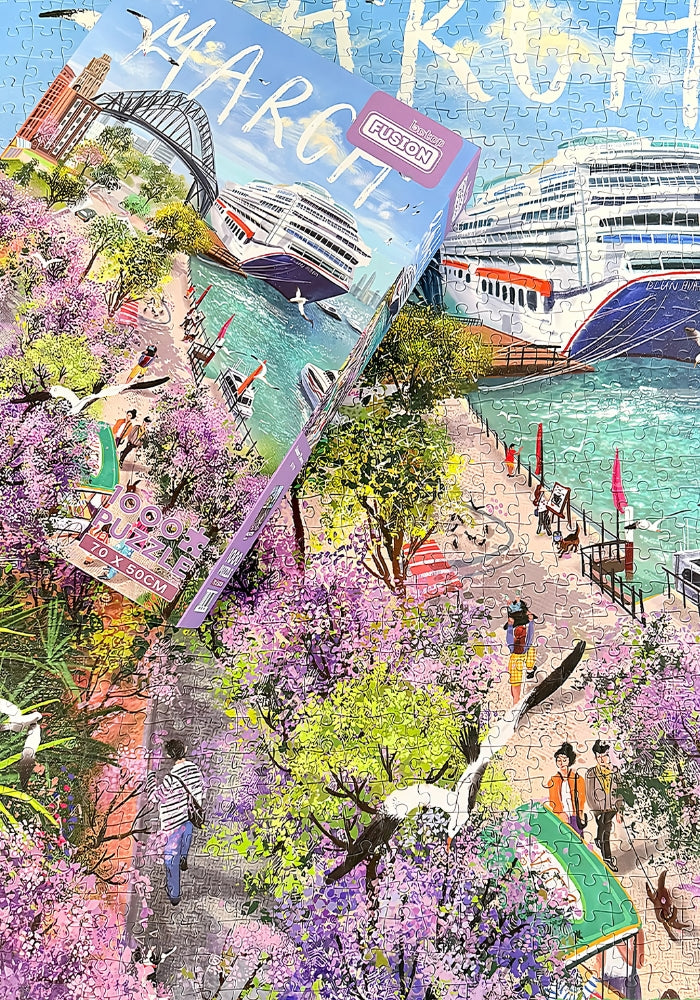 Completed Admire Flowers puzzle with the box placed on top, showing matching artwork of a harbour scene with cruise ship and