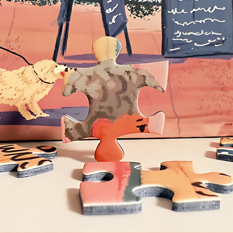 Loose puzzle pieces on table with artwork detail – seaside town puzzle.