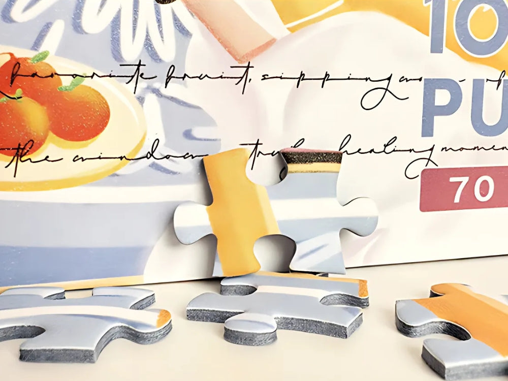 Puzzle pieces beside box with fruit and fabric detail – coastal living puzzle.