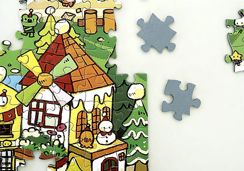 Close-up of edge pieces with windmill house, green trees and scattered snow ready to be placed