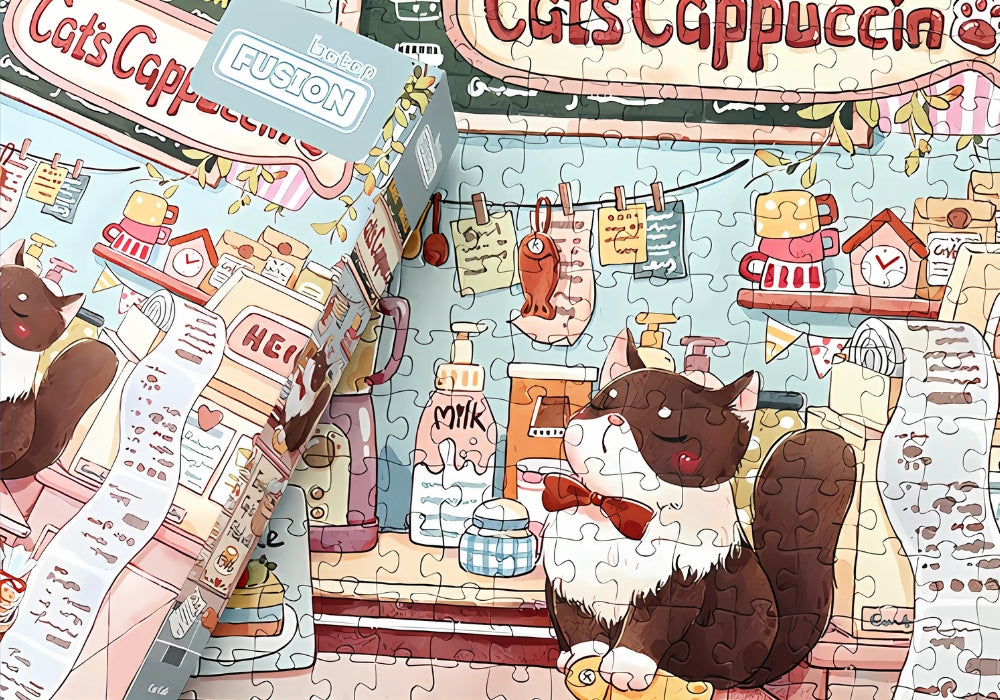 Close-up of the assembled Cat Cafe puzzle with the box placed on top.