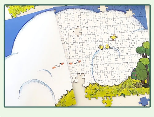 Puzzle in progress showing the large white cloud and birds in the sky.