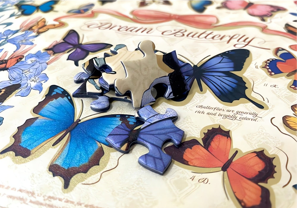Close-up of Butterfly puzzle pieces over artwork showing vibrant blue and orange butterfly illustrations.