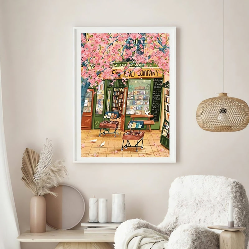 Framed "Sakura Bookstore" puzzle artwork in a warm, neutral-toned interior with soft lighting and boho decor.