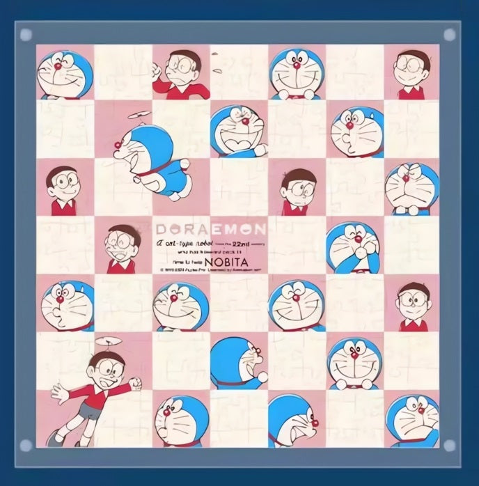 Flatlay image of the completed Doraemon checkerboard puzzle showing a symmetrical grid pattern with alternating Doraemon and