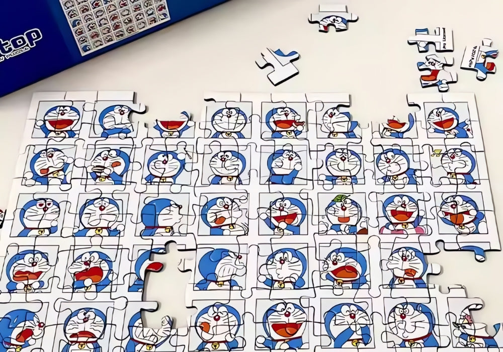 Close-up of Doraemon mini puzzle partially assembled on a table, showing various cartoon expressions.