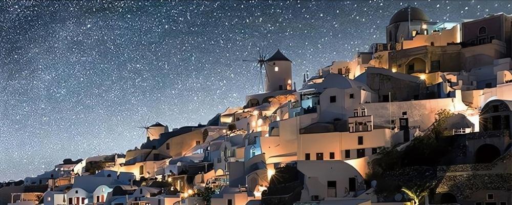 Santorini puzzle with glowing hillside homes and windmills beneath a starry sky.