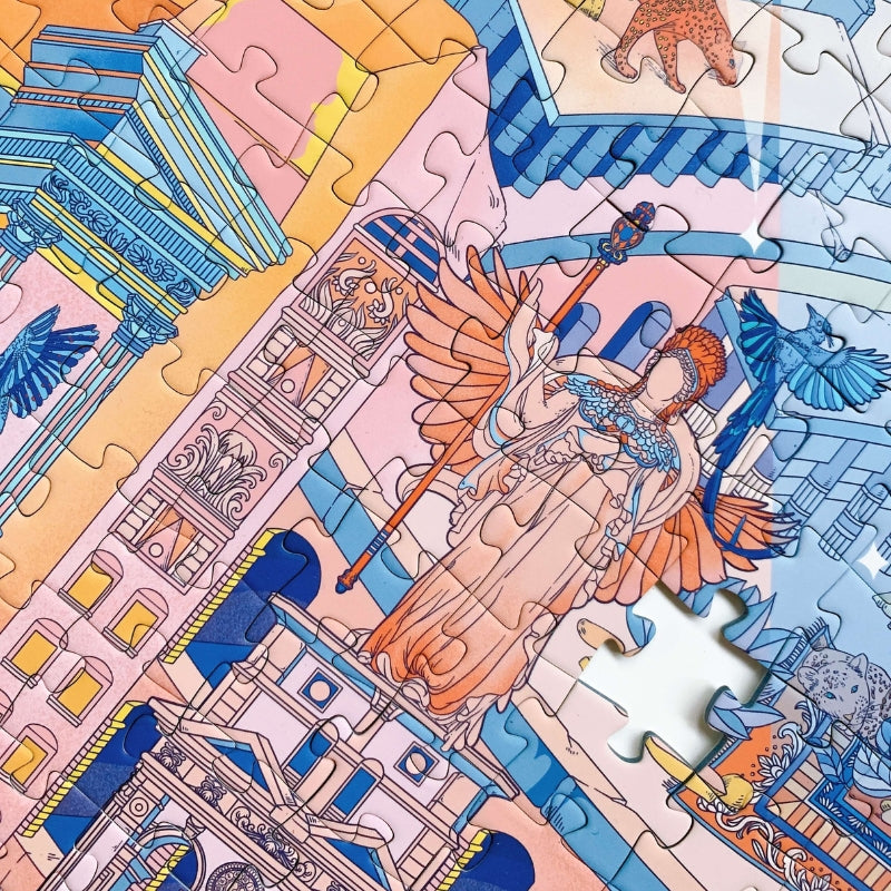 Close-up of assembled Garden of Eden puzzle showing intricate statue, pastel buildings, and vibrant bird illustration.