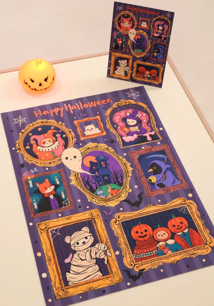 Finished puzzle laid flat on a white table next to a lit pumpkin candle and a smaller reference poster.