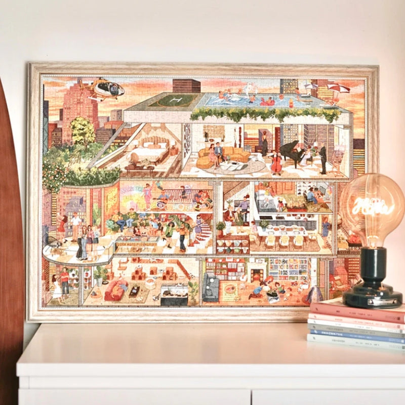 Completed PERMA ‘My Aspiration Modern Life’ 1000-piece puzzle framed and displayed on a white table beside a lamp.
