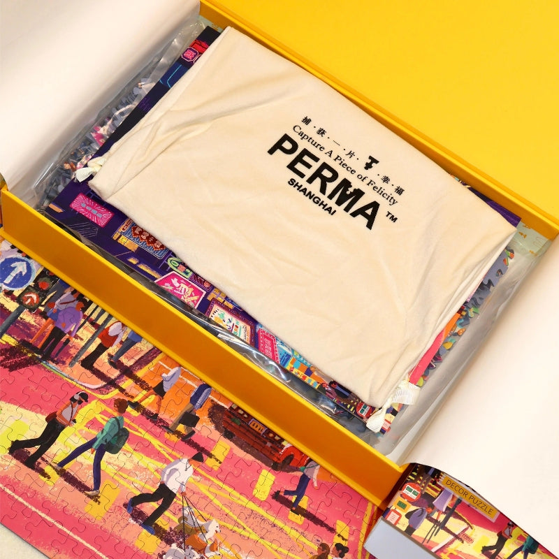 Inside view of the PERMA yellow storage box showing the puzzle pieces and white drawstring fabric bag.