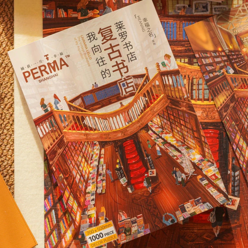 Cardboard stand-up reference sheet of the Livraria Lello puzzle artwork lying beside loose puzzle pieces.