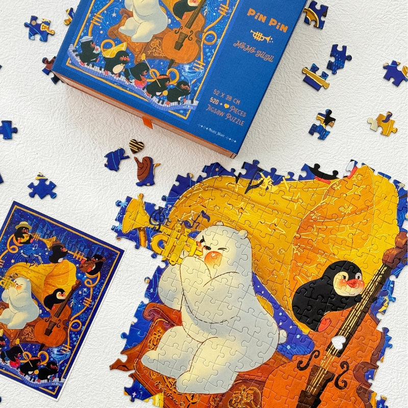 Blues Night puzzle being assembled alongside puzzle box and loose pieces, showcasing jazz band artwork.