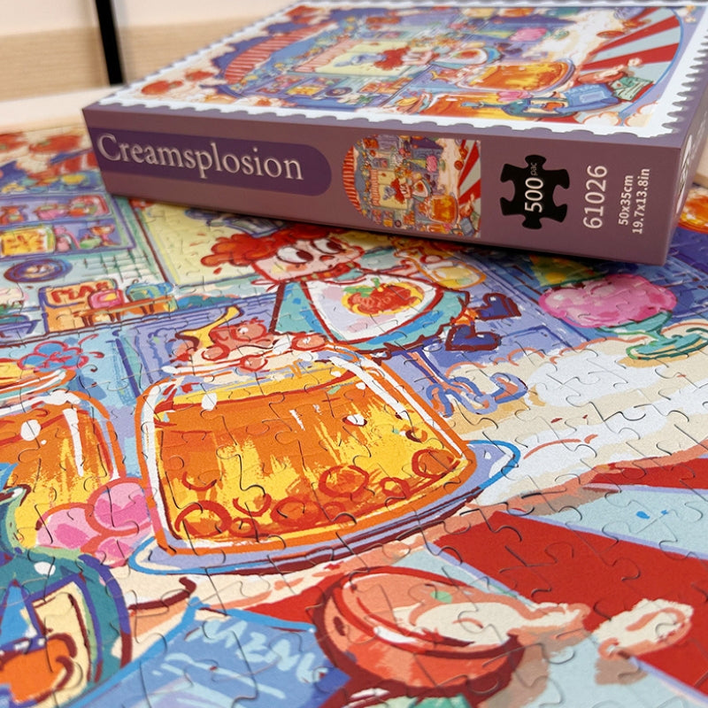 Close-up of completed Creamsplosion puzzle and box showing vibrant jars, sweets, and cartoon chef