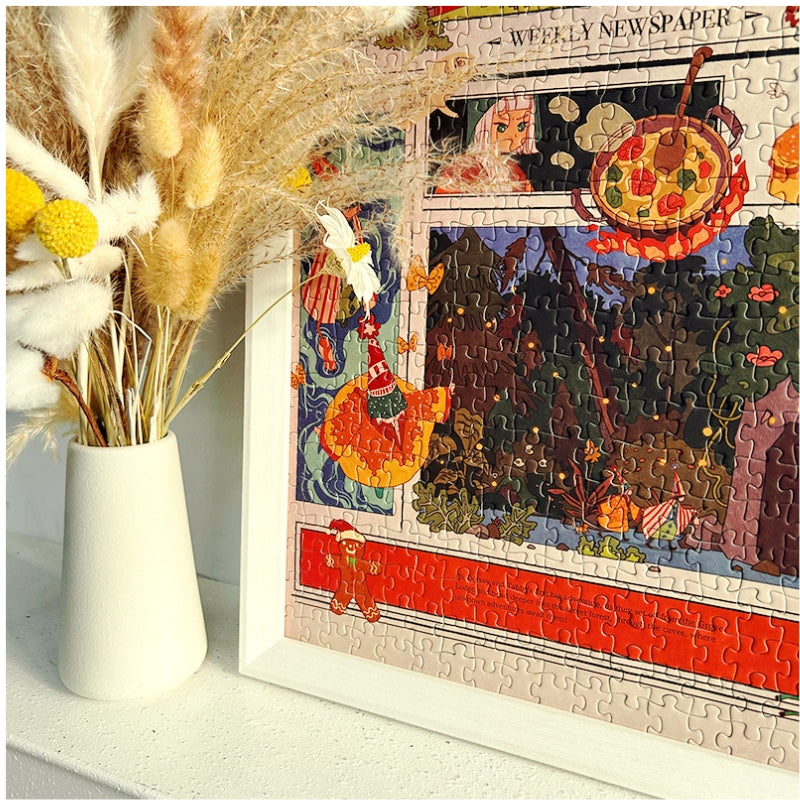 Completed Forest Party puzzle in white frame next to a vase of dried flowers, highlighting detailed forest artwork
