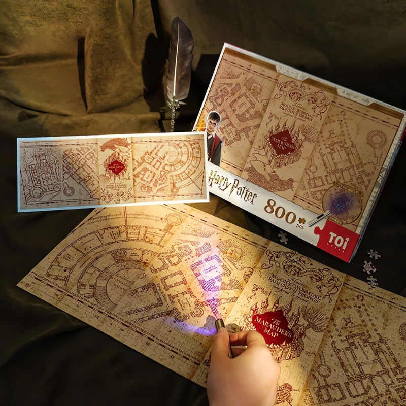 Harry Potter Marauder’s Map 800-piece puzzle by TOI, with glowing UV light effect and map design shown under torchlight.