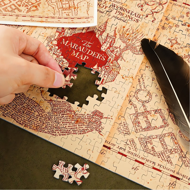 Hand placing a piece in the Marauder’s Map puzzle.