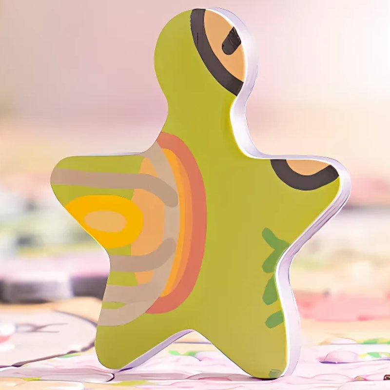 A custom-shaped star puzzle piece from the Maltese Puppy puzzle with light green and pastel designs.