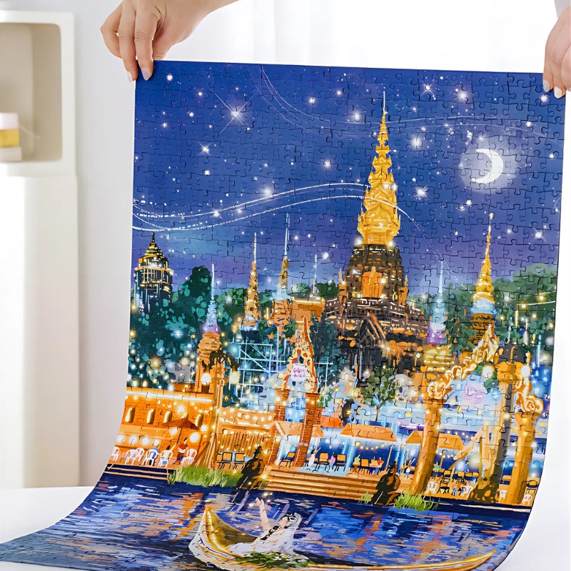 Person holding up the finished Moonlit Bazaar puzzle with shining temple and starry sky.