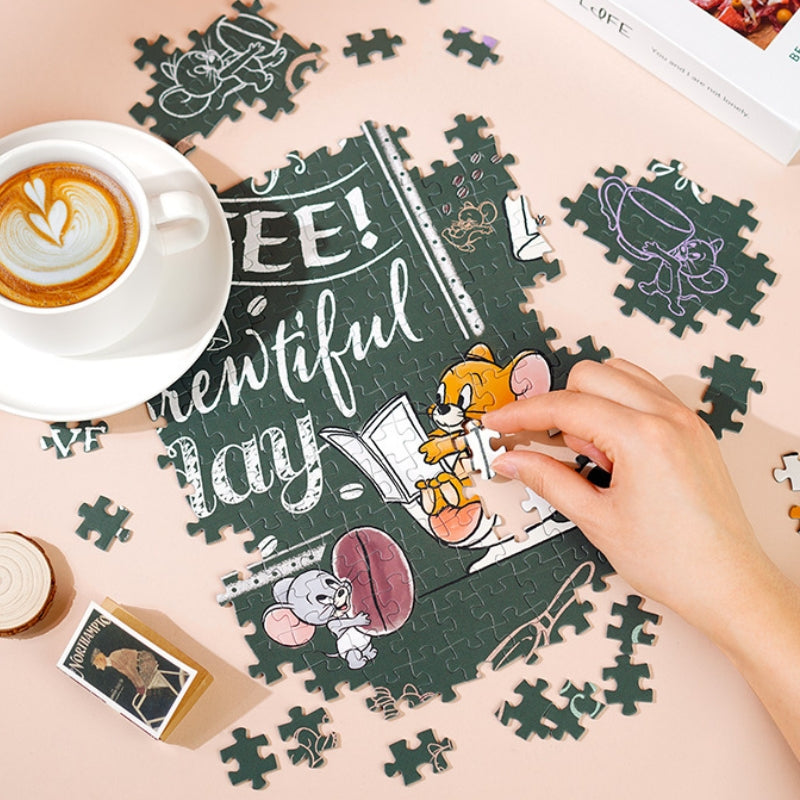 Hand placing a piece into the Coffee Time puzzle next to a latte on a peach-coloured table.