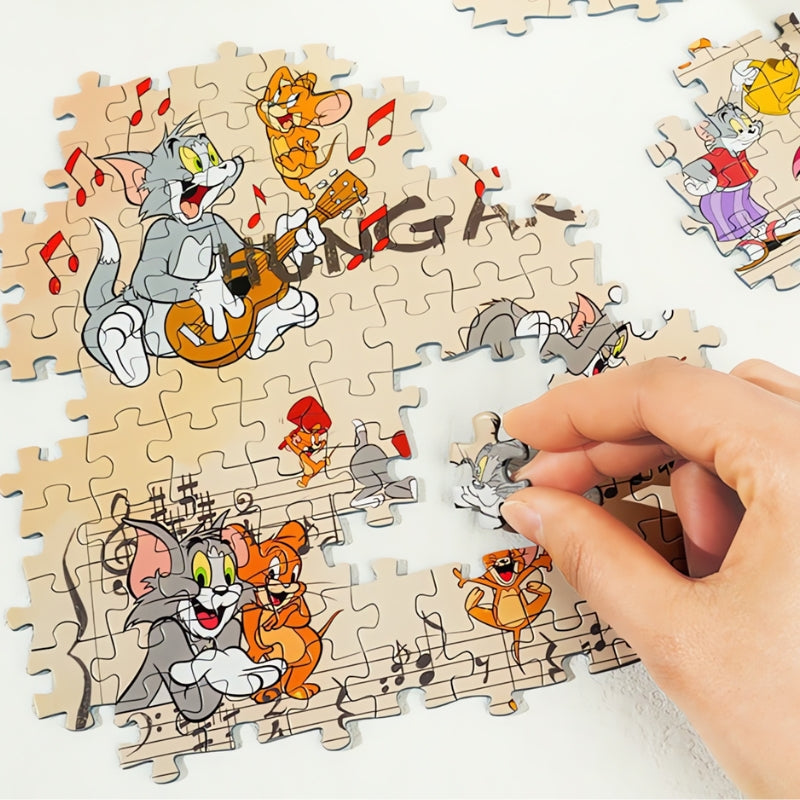 Hand placing a piece in the Hungarian Rhapsody puzzle featuring Tom, Jerry, and musical notes.