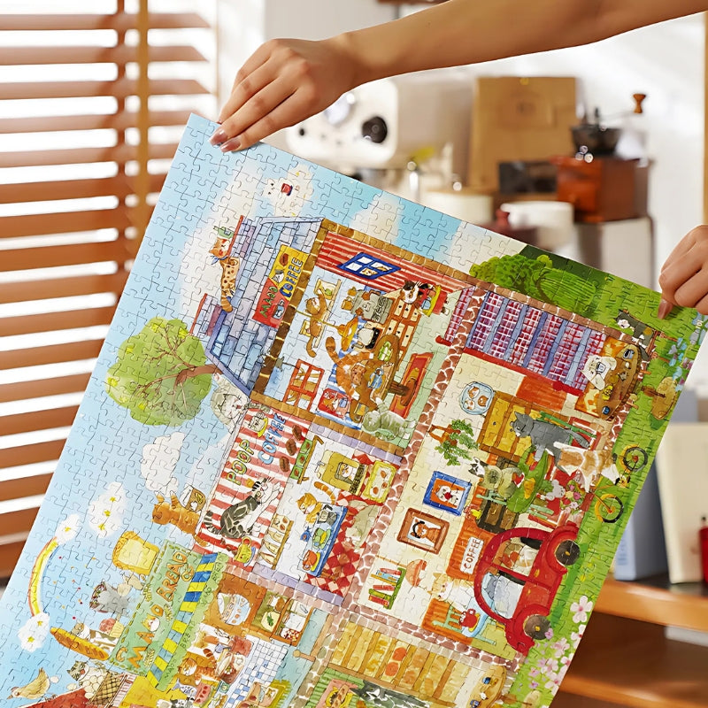 Person holding the fully assembled puzzle showing the full cat café scene.