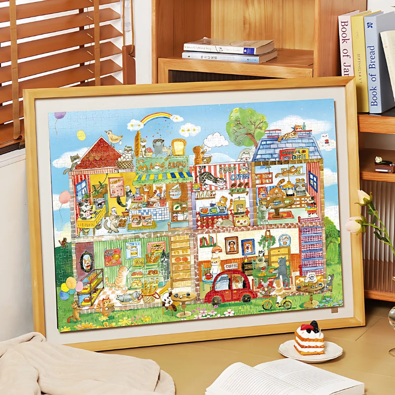 Framed and completed Café Paws & Whiskers puzzle displayed in a homey setting.