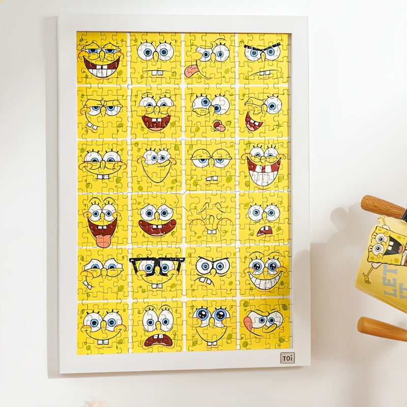 Framed SpongeBob Mood Diary puzzle displayed on wall with neat grid of expressive cartoon faces