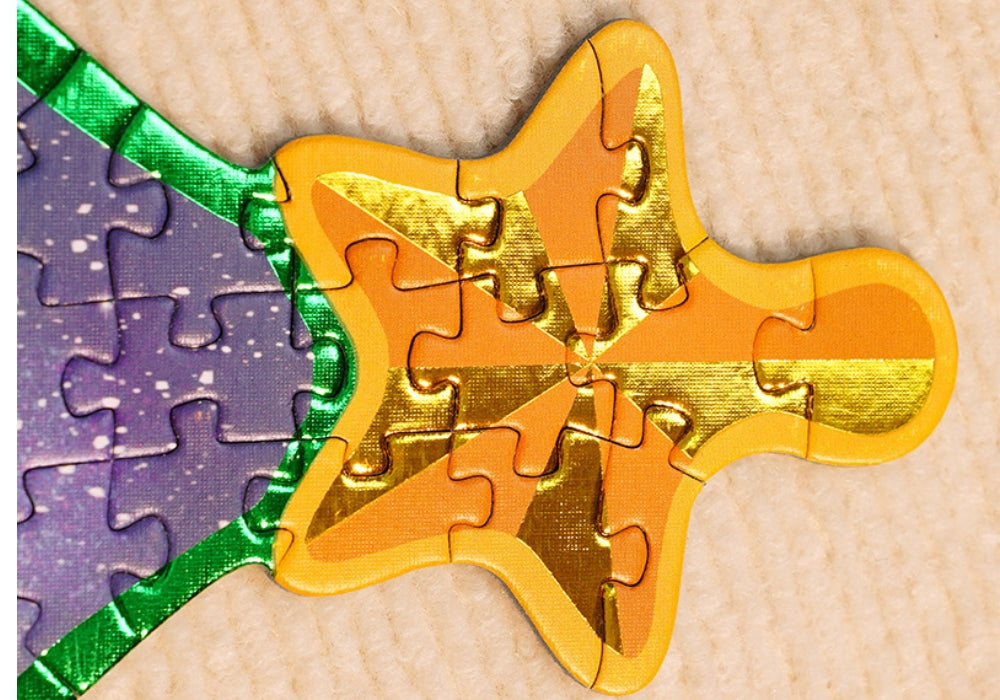 Close-up of the gold foil star detail from the Christmas Town puzzle top piece.