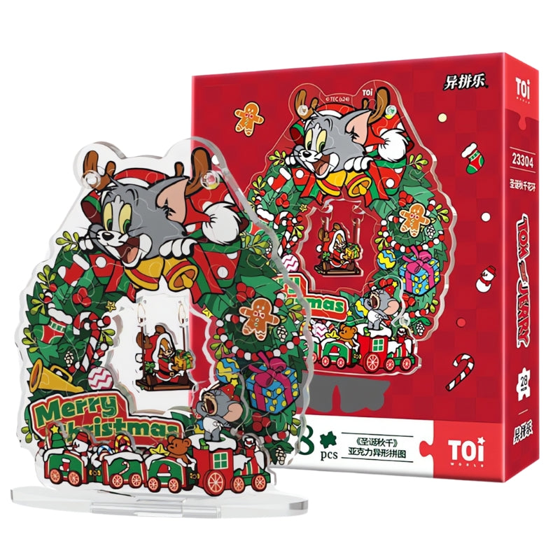 Tom and Jerry Christmas Swing Wreath acrylic puzzle displayed in front of the red TOI puzzle box with festive design.