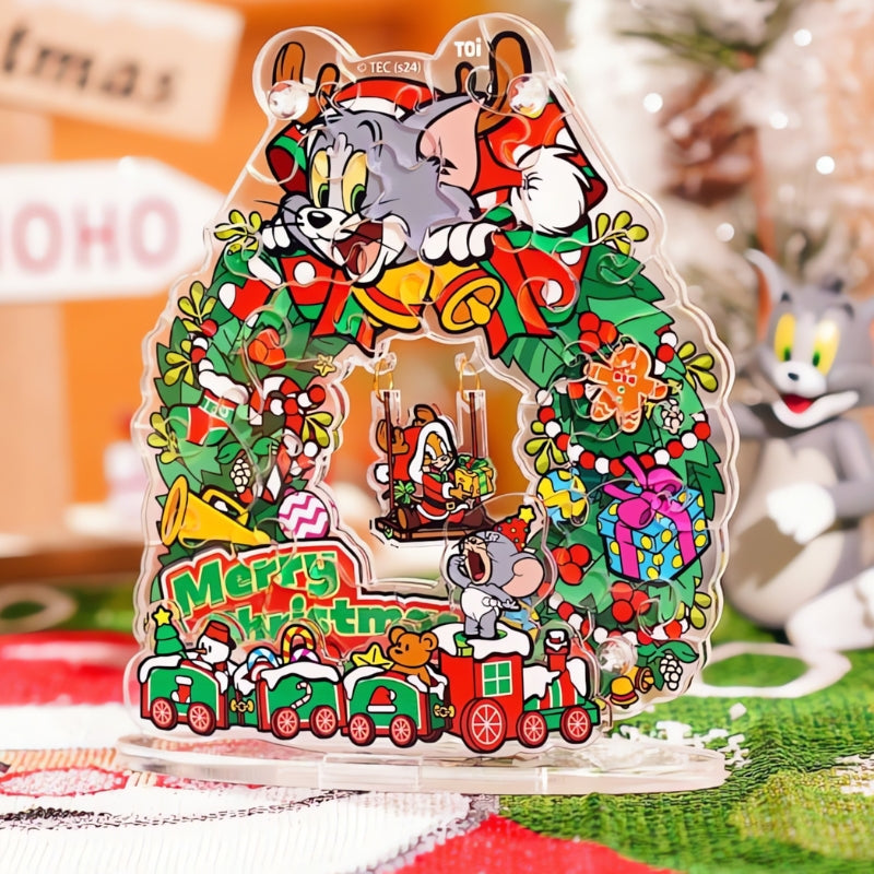 Completed Tom and Jerry Christmas Swing Wreath puzzle displayed on a festive table setting with Tom figure in the background.