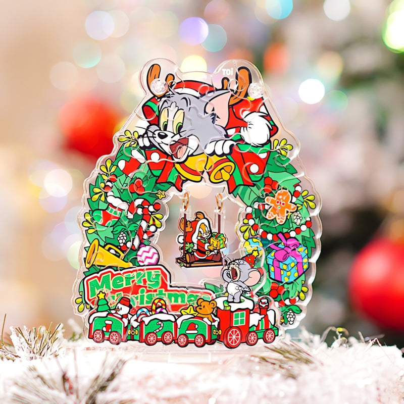 Completed Tom and Jerry Christmas Swing Wreath puzzle displayed on a festive table setting with Tom figure in the background.