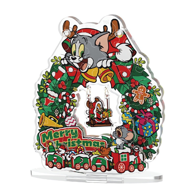 Front view of the fully assembled Tom and Jerry Christmas Swing Wreath acrylic puzzle on a clear display stand.
