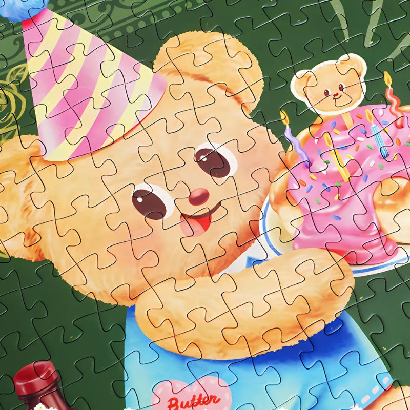 Puzzle detail showing Butterbear holding a birthday cake, emphasising bright colours and cute design.