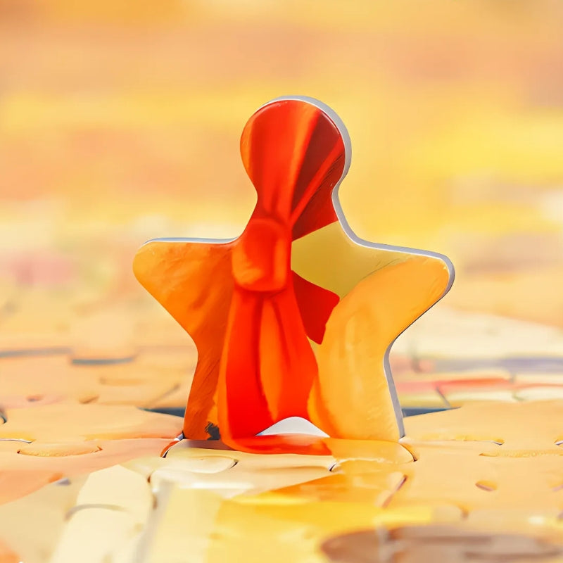 Close-up of a unique star-shaped puzzle piece from Butterbear – Dessert Paradise featuring red and orange tones.