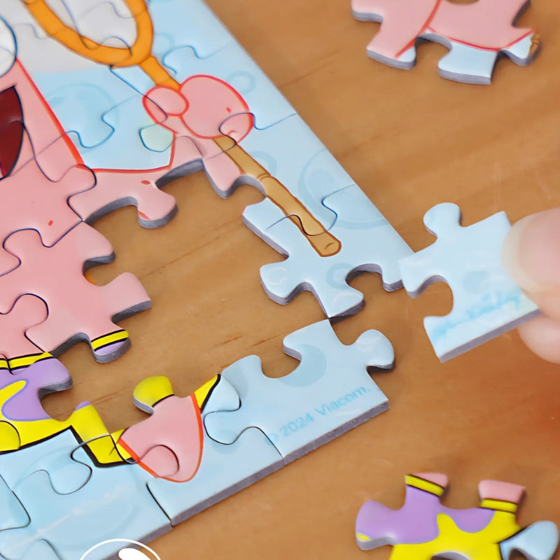 Puzzle piece being placed into Patrick-themed puzzle, highlighting the tight-fitting quality of the pieces.
