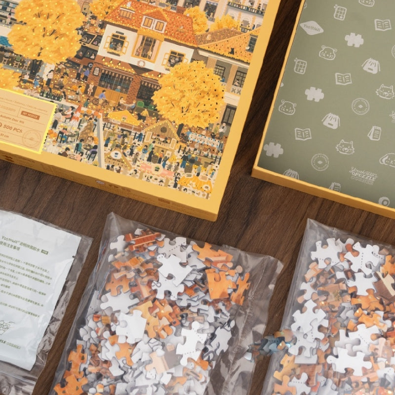 Open puzzle box with sealed puzzle bags, glue, and packaging.