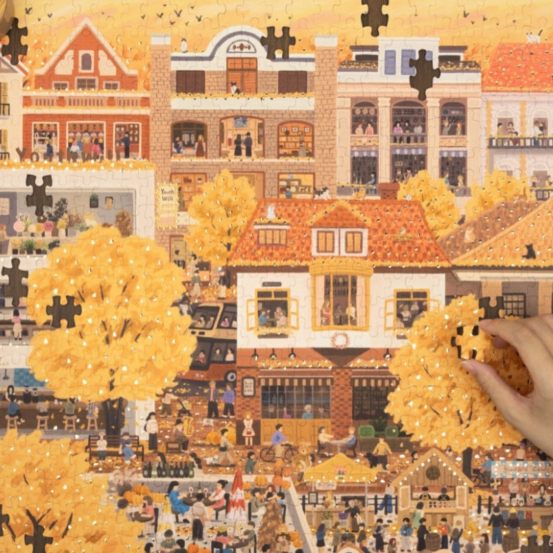Partially completed puzzle highlighting foil details on autumn leaves.