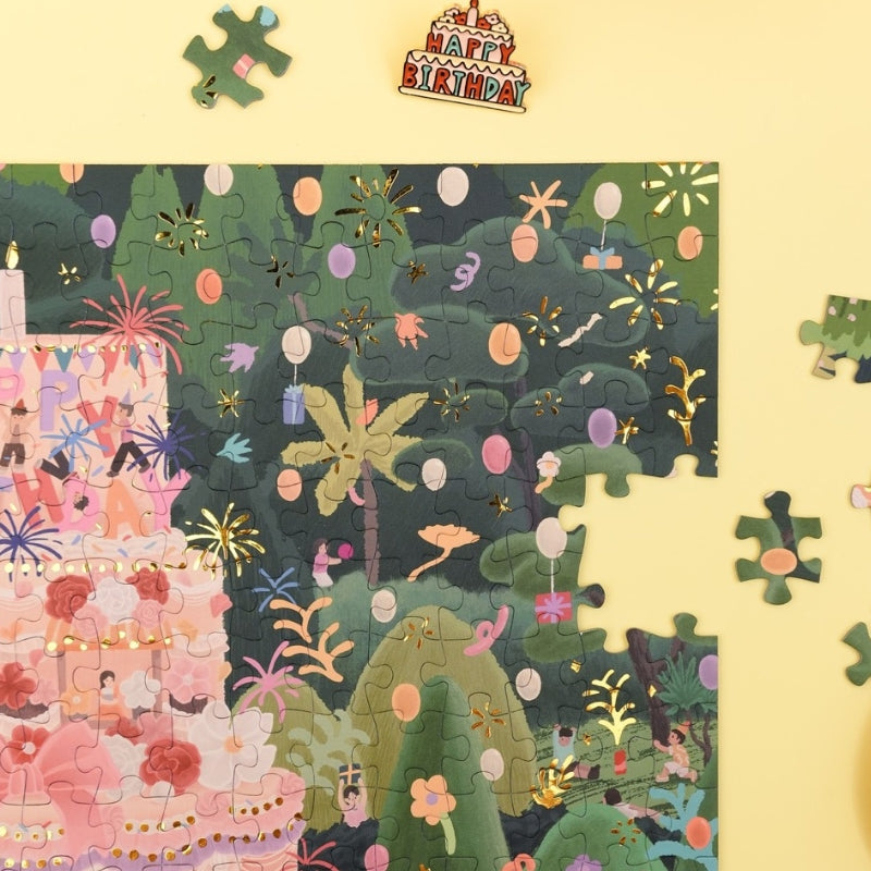 Partially completed puzzle with balloons, greenery, and foil details.